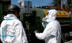 Japan-Fukushima-WorkersInProtectionSuits Japan-Fukushima-WorkersInProtectionSuits
