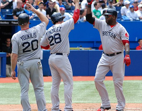 Kevin Youkilis (left) and Adrian Gonzalez (centre) congratulate David Ortiz (right) on his homerun for the Red Sox in the 5th inning