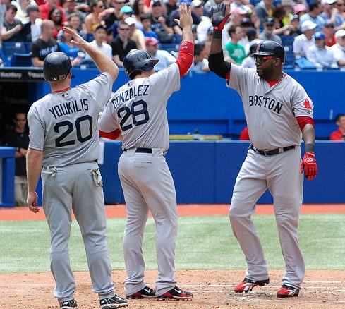 Kevin Youkilis (left) and Adrian Gonzalez (centre) congratulate David Ortiz (right) on his homerun for the Red Sox in the 5th inning