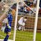 Canadian goalkeeper Lars Hirchfeld gathers his thoughts after giving up a bad first goal. The US players celebrate in the background.