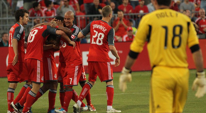 Whitecaps goalkeeper Jay Nolly watches TFC players celebrate Nick Soolsma's successful penalty kick in the second half