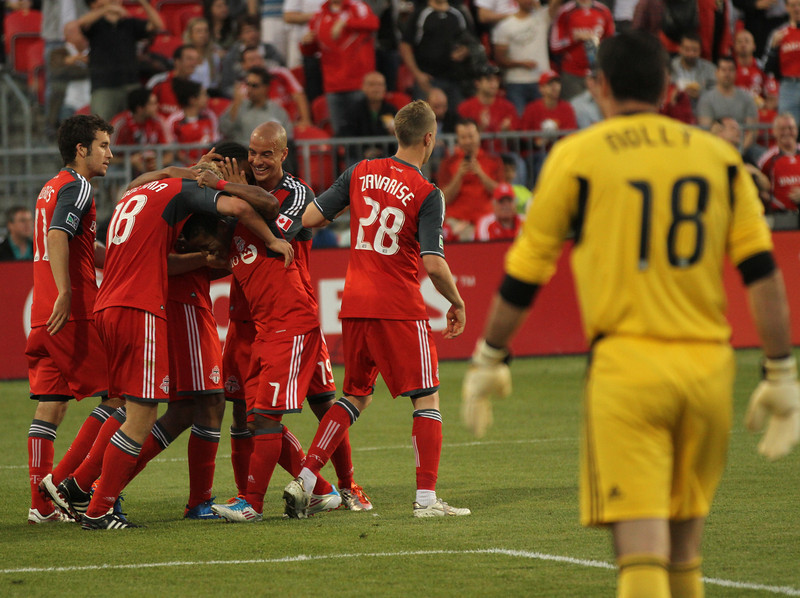 Whitecaps goalkeeper Jay Nolly watches TFC players celebrate Nick Soolsma's successful penalty kick in the second half