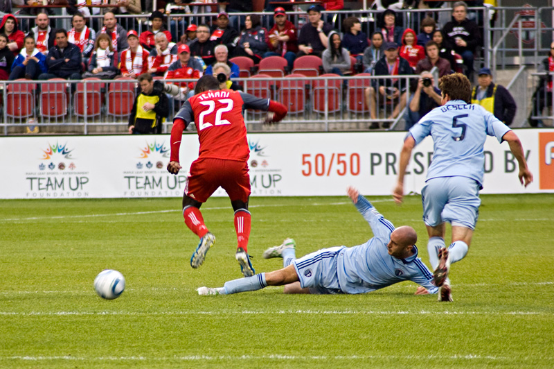 Kansas City's Aurelien Collin (centre) knocks the ball away from TFC's Tony Tchani Kansas City's Aurelien Collin (centre) knocks the ball away from TFC's Tony Tchani