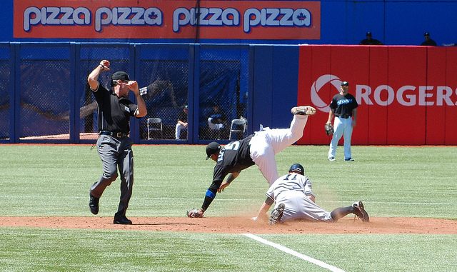 Yankee centre fielder Brett Gardner slides into second with a stolen base despite Yunel Escobar's acrobatic efforts