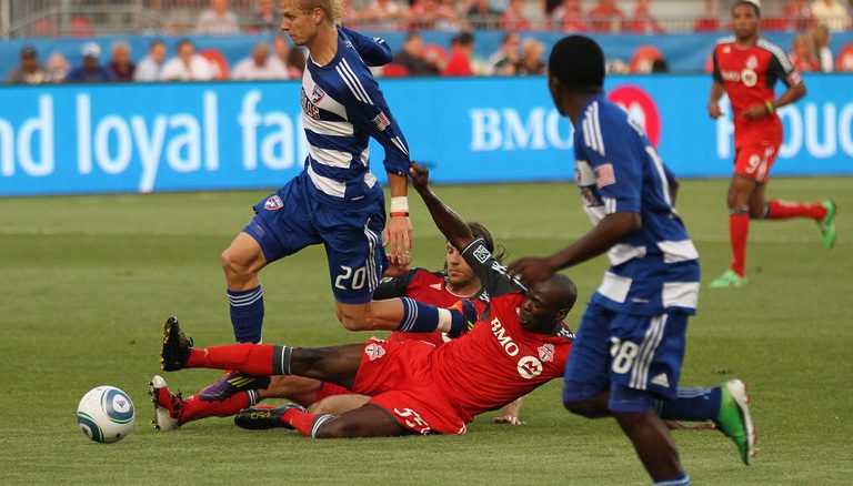 New TFC defender Eddy Viator drags down Dallas midfielder Brek Shea in the first half