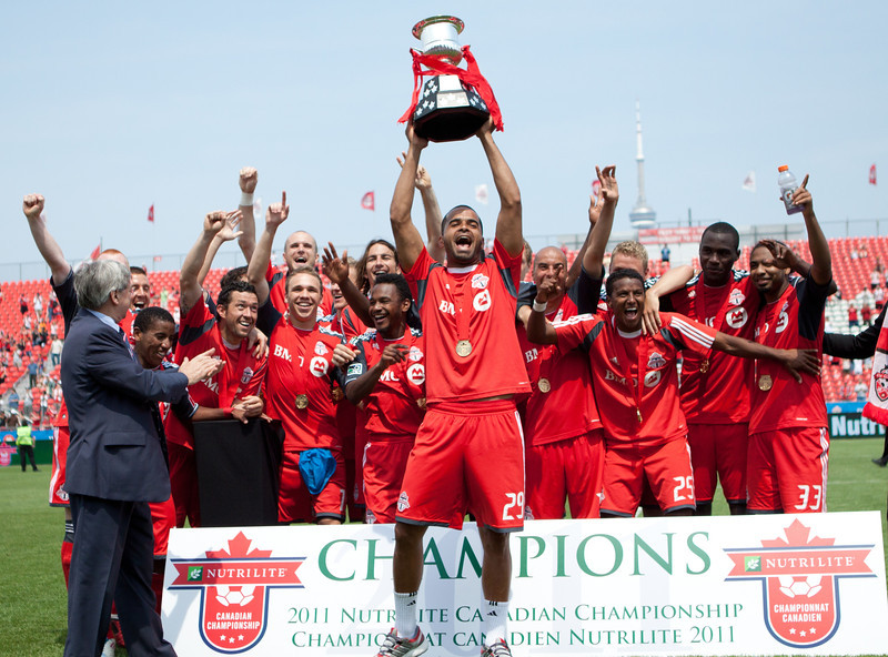 With his teammates behind him, TFC Captain Maicon Santos hoists the Voyageurs Cup in celebration of winning the NCC