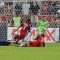 Former Red Jacob Peterson (left) is knocked down by TFC defender Andy Iro (centre)