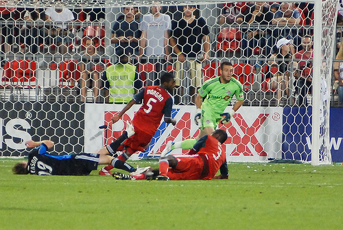 Former Red Jacob Peterson (left) is knocked down by TFC defender Andy Iro (centre) Former Red Jacob Peterson (left) is knocked down by TFC defender Andy Iro (centre)