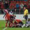 Toronto FC players jump on striker Danny Koevermans in celebration of his goal in the first half (John Lucero)