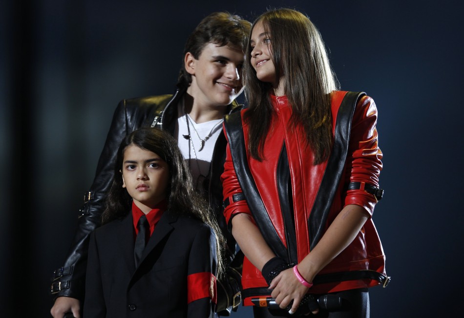 171032-michael-jacksons-children-l-r-blanket-prince-and-paris-stand-on-stage-