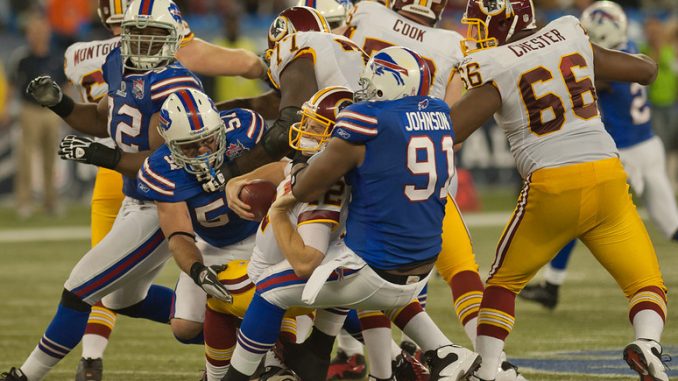 Washington Redskins quarterback John Beck is sacked by Buffalo Bills linebacker Danny Batten and defensive end Spencer Johnson at Rogers Centre Sunday (John Lucero)