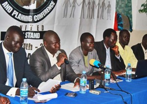 The chairperson of the convention organising committee Angok Akuien (holding microphone) briefs the press in Juba.[©Gurtong]