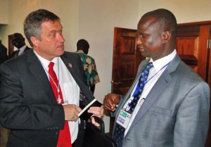 Unity State Governor Taban Deng Gai (right) confers with a guest at the ongoing Governors’ Forum in Juba. [©Gurtong]