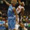 Oshawa Power small forward Marcus Johnson wins the battle of number 1's as he slams the ball down onto the face of former NBA player Eddie Robinson of the Halifax Rainmen.