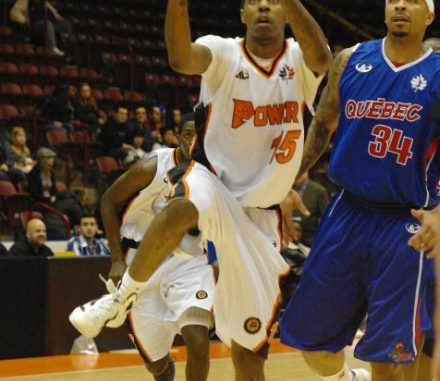 Oshawa Power guard drives to the net as Quebec Kebs forward James "Boo" Jackson looks on