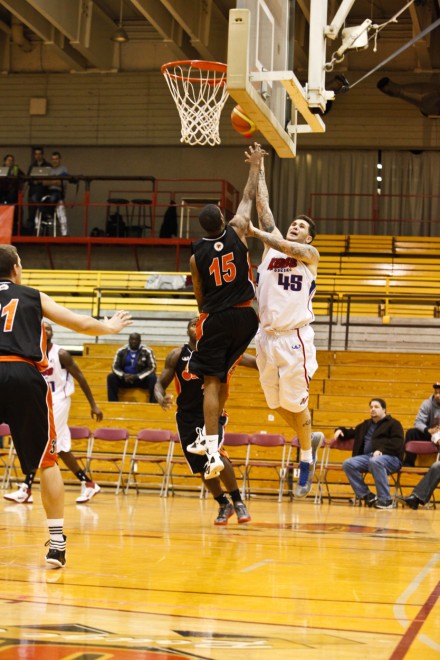 Oshawa Power guard Brandon Robinson jumps up to contest a shot from the Quebec Kebs Oshawa Power guard Brandon Robinson jumps up to contest a shot from the Quebec Kebs