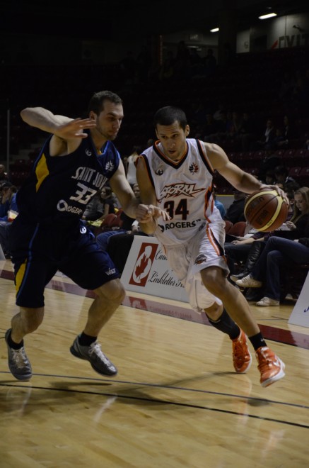 Summerside Storm small forward Chris Cayole (right) drives past Saint John Mill Rats forward Steve DeLuca Summerside Storm small forward Chris Cayole (right) drives past Saint John Mill Rats forward Steve DeLuca
