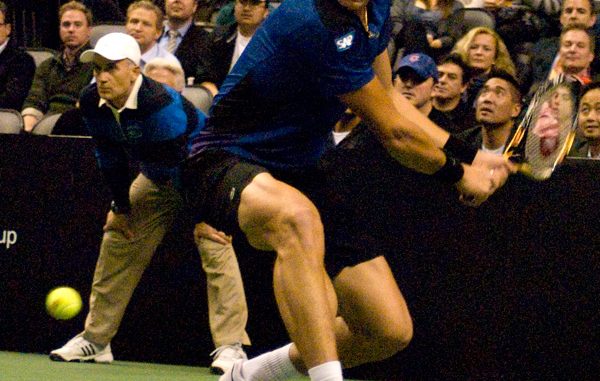 Milos Raonic prepares to return a backhand during his exhibition match against Pete Sampras