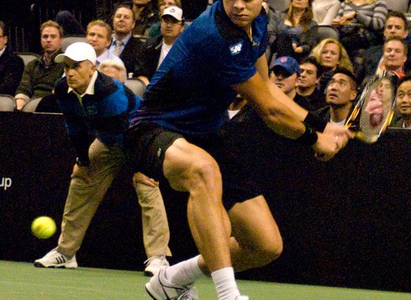 Milos Raonic prepares to return a backhand during his exhibition match against Pete Sampras