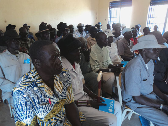 Chiefs follow the Commissioner's message during the opening of the workshop in Kapoeta North County [©Gurtong]