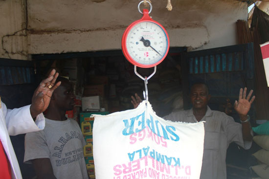 (L-R) Mr. Pangui and Rahma weighing a 50kg of flour during the random inspection by authorities in Juba [©Gurtong]
