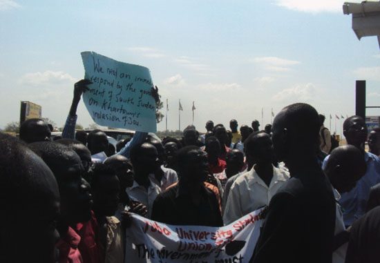 The students holding placards at the National Assembly premises during the procession [©Gurtong]
