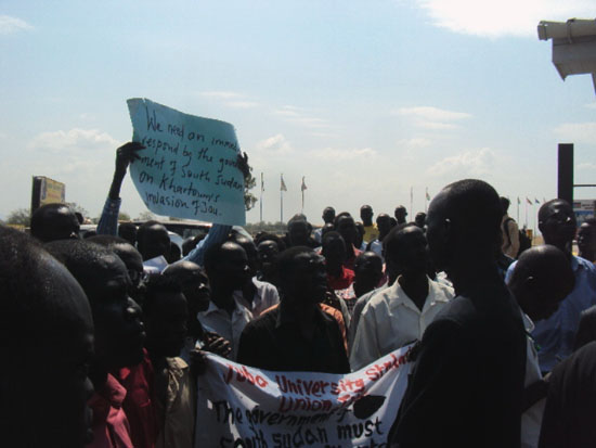 The students holding placards at the National Assembly premises during the procession [©Gurtong]