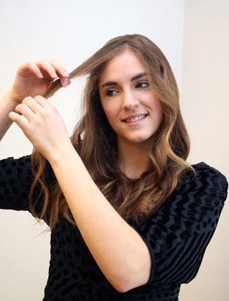 1. Start by taking a one-inch section of hair at your hairline and loosely pulling it forward.