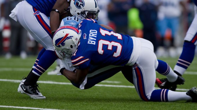 Buffalo Bills free safety Jarius Byrd tackles Tennessee Titans running back Chris Johnson at Ralph Wilson Stadium on Sunday afternoon (JP Dhanoa)