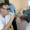 Dr. Sture Nyolme examining a patient's eyes as other patients wait to be attended to at Torit Hospital in Torit [©Gurtong]