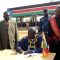 Governor Louis Lobong (centre) signing the constitution at Torit freedom square as the judiciary team witnessed [©Gurtong]