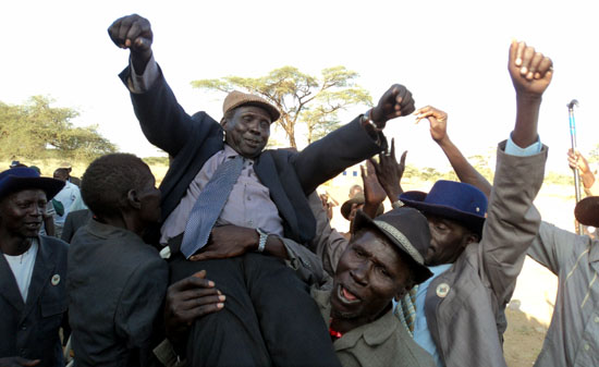 Victory: Kapoeta North County officials cheerfully carrying their new Paramount chief after winning elections in Riwoto [©Gurtong]