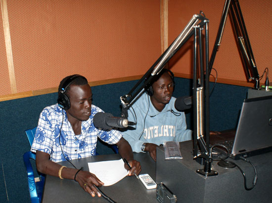 Some of the new “Voice of Freedom” radio station presenters reading news to listeners in Magwi County [©Gurtong]