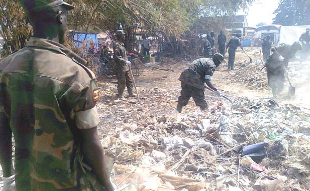 Uganda People’s Defence Force personnel cleaning Yambio market in commemoration of Army Week Day [©Gurtong]