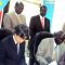 (L-R) JICA Representative and Information Undersecretary George Garang signing the deal at the Information Ministry [©Gurtong]