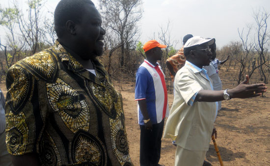 Sports Minister Dr. Cirino Hiteng Ofuho pointing to the land offered for building a sports complex in Lokiliri Payam [©Gurtong]