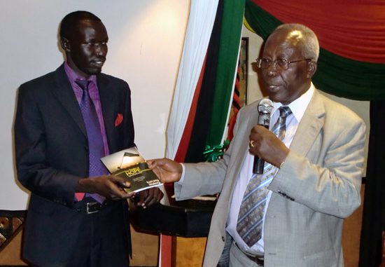 Professor Sam Ongeri (right) hands over the new book to Mr. Garang Malong (left) to mark its official launch in Nairobi [©Gurtong]