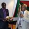Professor Sam Ongeri (right) hands over the new book to Mr. Garang Malong (left) to mark its official launch in Nairobi [©Gurtong]
