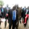 Mr. John Penn cutting the ribbon to open the trade fair as government officials and the Ambassador of Kenya to South Sudan look on [©Gurtong]