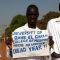 Medical students display a flyer during the demonstration outside the University [©Gurtong]