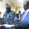 Mireille Girard (Left) exchanging the signed documents with Mr. Augustino Maduot (Right) at the Immigration offices in Juba [©Gurtong/ Juma Stephen]