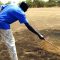 Mapel police officer, Mayen Atem pointing at the smoky substance and the burnt soil in Mapel [©Gurtong/ James Deng]