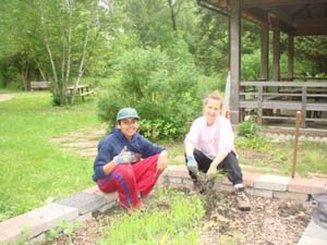 Harnoor Gill. Willow Park Ecology Centre (WPEC) Youth Volunteer Leader with Tunde Otto-Harris, Chair Stewardship Committee of WPEC is cleaning the vegetable garden at WPEC in spring 2011