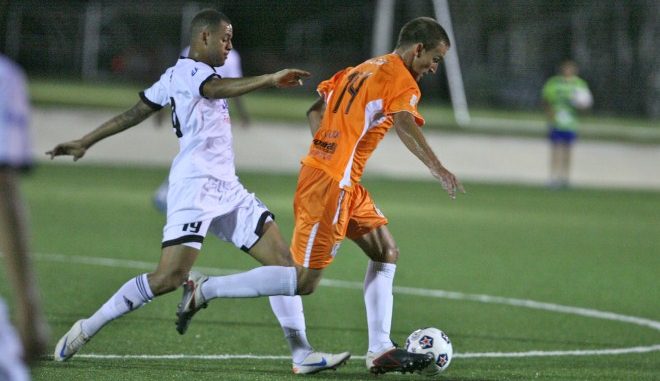 FC Edmonton's Kyle Porter fights for a ball against the Puerto Rico Islanders' Jared Van Schaik in Bayamon on Wednesday evening. The two teams battled to 0-0 draw, the Eddies' first point of the season.