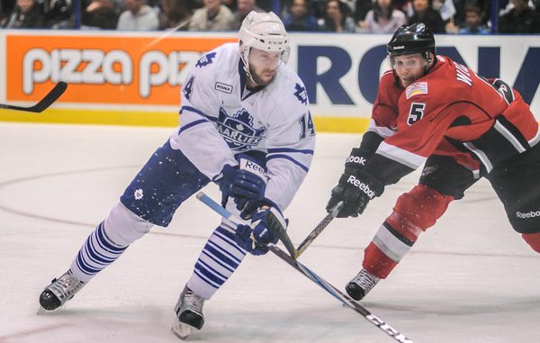 Abbotsford Heat defenceman Clay Wilson slashes at the stick of Toronto Marlies winger Will Acton (Karan Vyas)