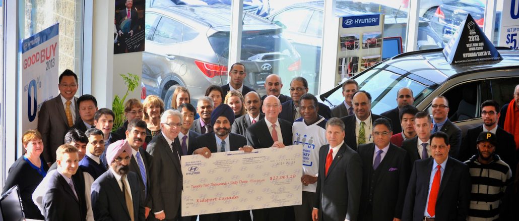 Nav Bhatia, dealer principal of Mississauga Hyundai, presents a $22,063 donation for the Hyundai Hockey Helpers initiative to Hyundai Auto Canada Corp. President and CEO Steve Kelleher, Hyundai Hockey Helpers Ambassador Karl Subban, and KidSport Canada representatives.
