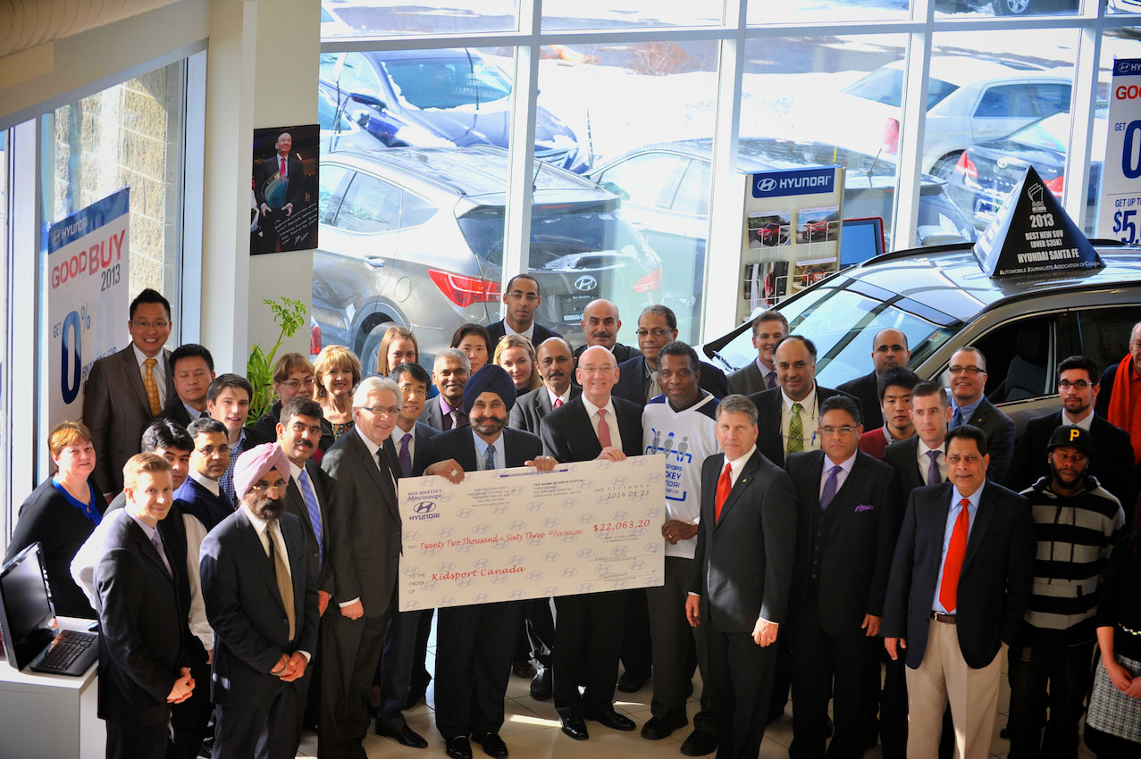 Nav Bhatia, dealer principal of Mississauga Hyundai, presents a $22,063 donation for the Hyundai Hockey Helpers initiative to Hyundai Auto Canada Corp. President and CEO Steve Kelleher, Hyundai Hockey Helpers Ambassador Karl Subban, and KidSport Canada representatives. Nav Bhatia, dealer principal of Mississauga Hyundai, presents a $22,063 donation for the Hyundai Hockey Helpers initiative to Hyundai Auto Canada Corp. President and CEO Steve Kelleher, Hyundai Hockey Helpers Ambassador Karl Subban, and KidSport Canada representatives.