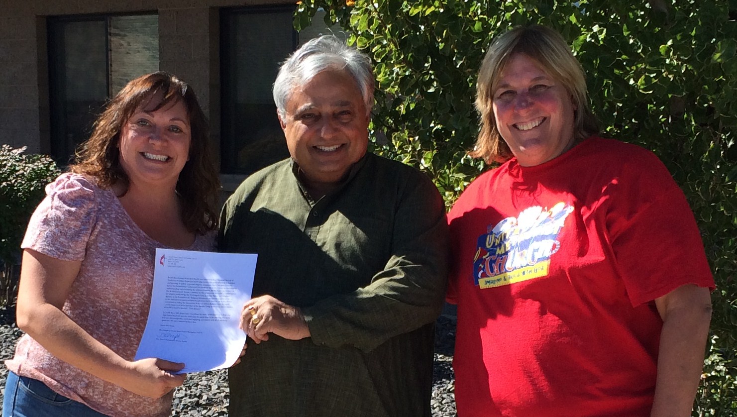 Rajan Zed receiving a testimonial at South Reno United Methodist Church. From left to right are—Dawn Pidlypchak, Rajan Zed and Pastor Becky Stockdale.
