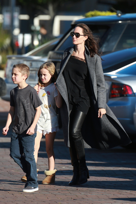 angelina jolie dashes to the market in leather and lace