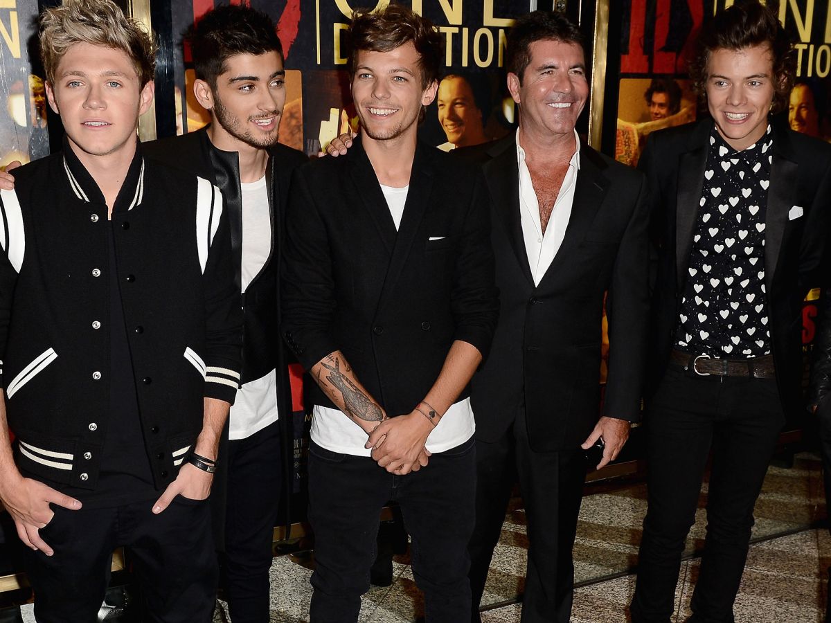 simon cowell says the successes of one direction members make him feel “like a proud dad”